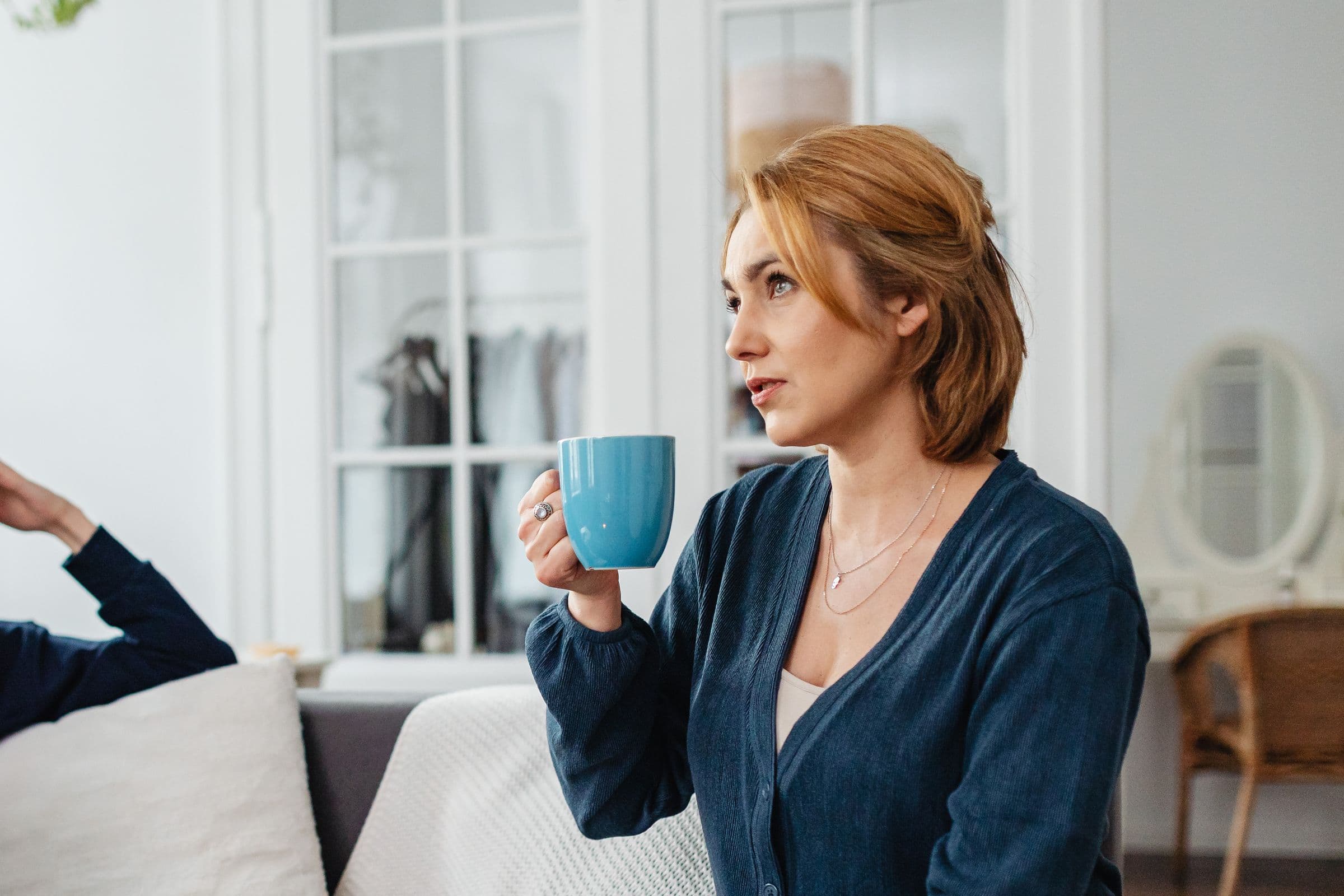 Someone at home with a coffee while the paperwork gets handled.
